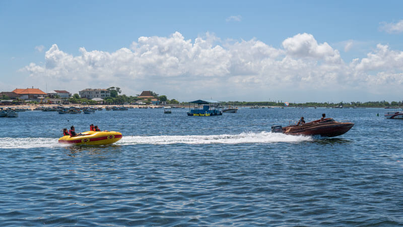 Wisatawan menikmati perjalanan dengan Rolling Donut yang ditarik oleh speedboat di Pantai Tanjung Benoa.