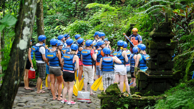 Peserta rafting mendapatkan briefing keselamatan di hutan tropis Bali sebelum memulai petualangan di Sungai Ayung.