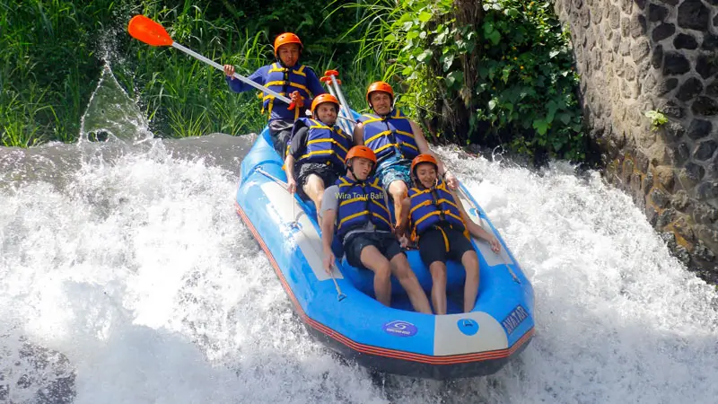 Rombongan rafting meluncur di jeram drop dengan arus kuat